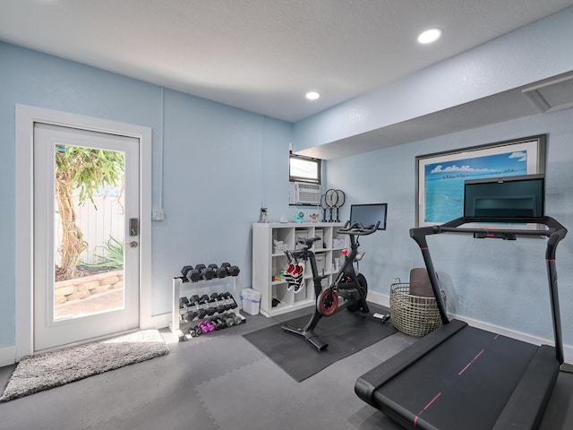 workout room featuring cooling unit and recessed lighting