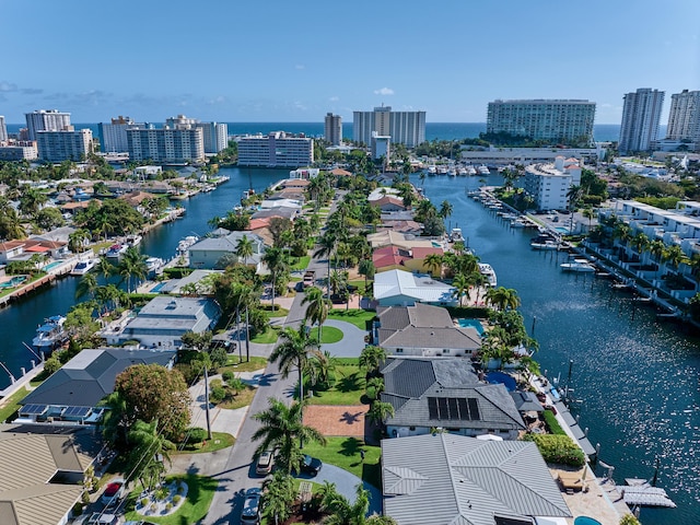 birds eye view of property with a water view and a city view