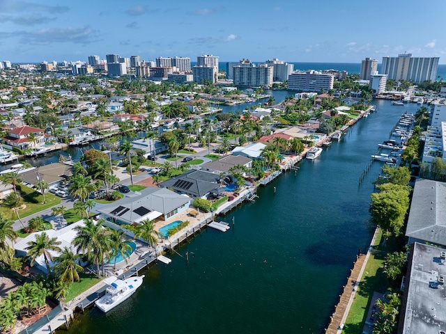 birds eye view of property featuring a view of city and a water view