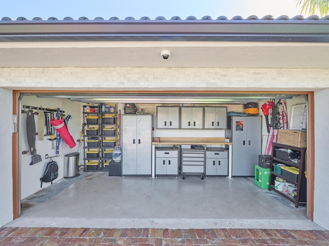 garage featuring decorative driveway