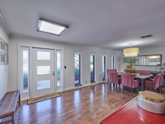 foyer entrance featuring visible vents, crown molding, and baseboards