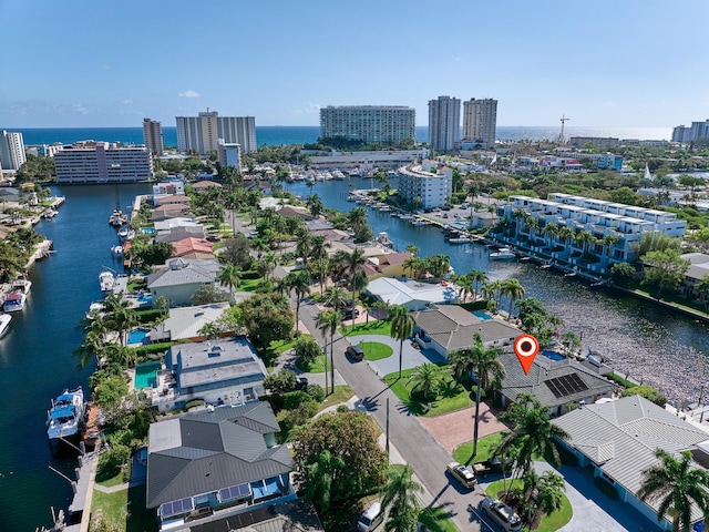 birds eye view of property with a view of city and a water view