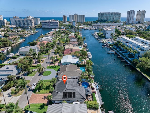 birds eye view of property with a water view and a view of city