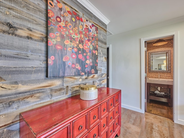 interior space with ornamental molding and baseboards