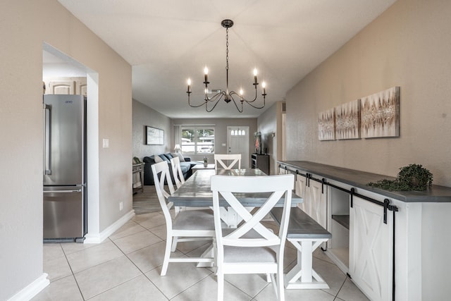 dining space with light tile patterned flooring, an inviting chandelier, and baseboards