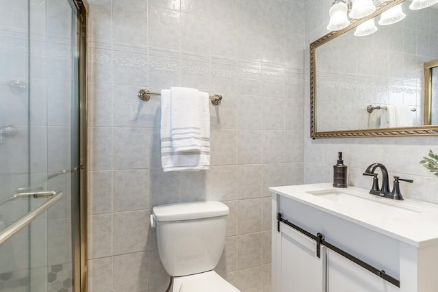 full bathroom featuring toilet, vanity, tile walls, a shower stall, and decorative backsplash