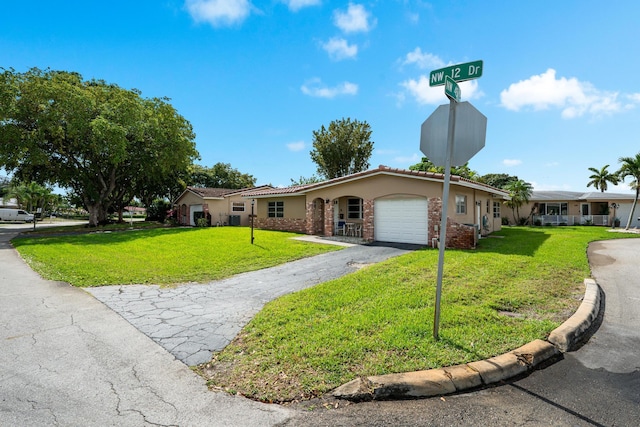 single story home with a garage, a front yard, stucco siding, and aphalt driveway