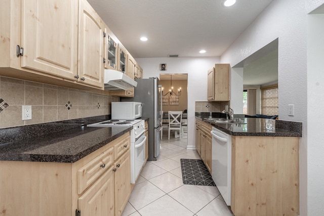 kitchen with light tile patterned floors, white appliances, light brown cabinets, and under cabinet range hood