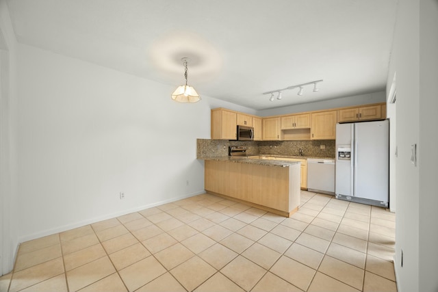 kitchen featuring white appliances, tasteful backsplash, baseboards, a peninsula, and light brown cabinetry