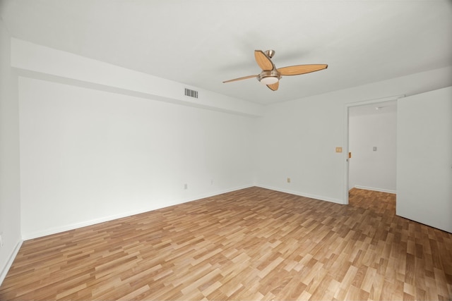 empty room with ceiling fan, baseboards, visible vents, and light wood-style floors