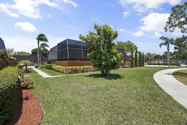 view of community featuring fence and a lawn