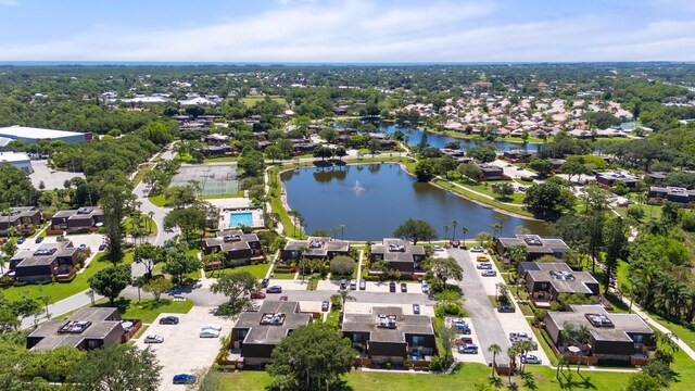 birds eye view of property with a water view and a residential view