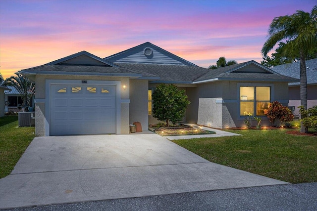 6625 Alheli Ct, Fort Pierce, FL 34951 - ranch-style house with concrete driveway, central AC, a front yard, stucco siding, and a garage