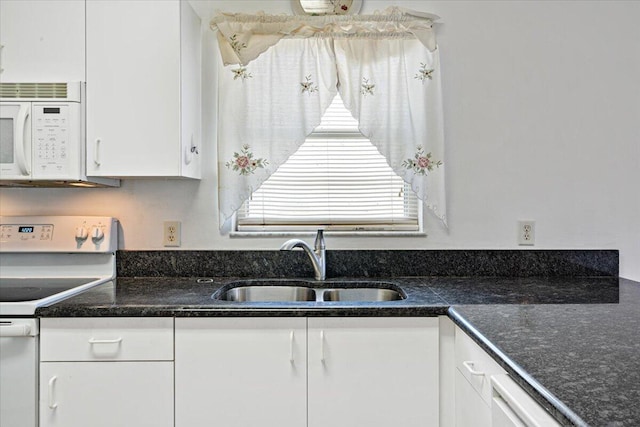 6625 Alheli Ct, Fort Pierce, FL 34951 - kitchen with a sink, dark stone counters, white appliances, and white cabinetry