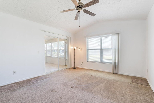 6625 Alheli Ct, Fort Pierce, FL 34951 - unfurnished bedroom featuring a ceiling fan, a textured ceiling, carpet flooring, baseboards, and vaulted ceiling