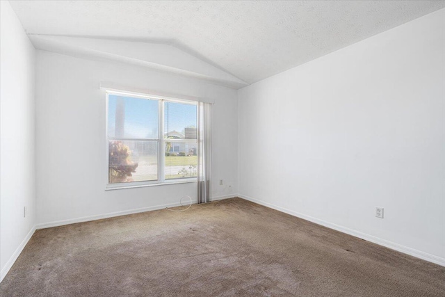 6625 Alheli Ct, Fort Pierce, FL 34951 - carpeted spare room with a textured ceiling, baseboards, and vaulted ceiling