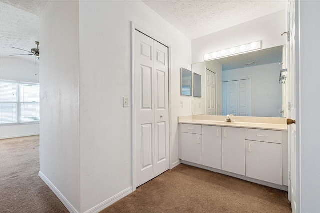 6625 Alheli Ct, Fort Pierce, FL 34951 - bathroom with baseboards, ceiling fan, vanity, carpet flooring, and a textured ceiling