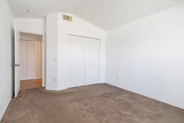 6625 Alheli Ct, Fort Pierce, FL 34951 - unfurnished bedroom featuring baseboards, visible vents, carpet floors, lofted ceiling, and a closet