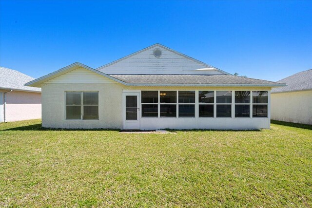 6625 Alheli Ct, Fort Pierce, FL 34951 - back of property with a lawn and a sunroom