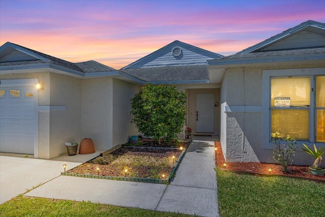 6625 Alheli Ct, Fort Pierce, FL 34951 - view of front of property featuring stucco siding, an attached garage, and a shingled roof