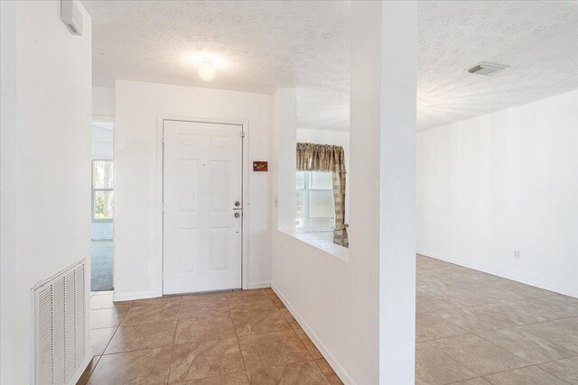 spare room featuring baseboards and an inviting chandelier