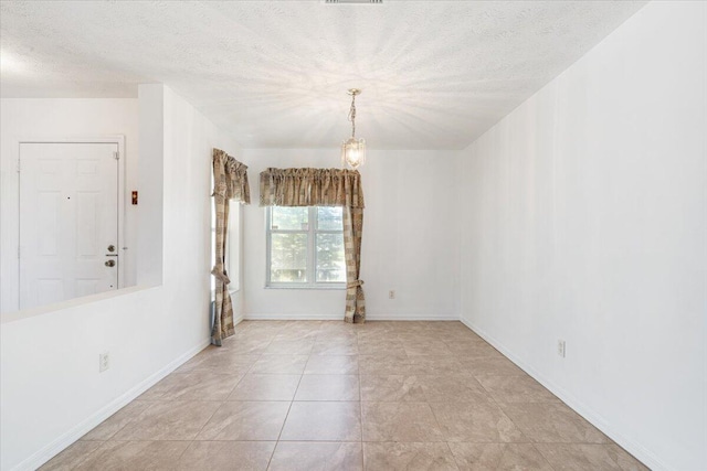 6625 Alheli Ct, Fort Pierce, FL 34951 - spare room with baseboards, a textured ceiling, and an inviting chandelier