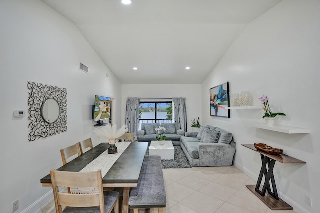 dining area with light tile patterned floors, recessed lighting, baseboards, and high vaulted ceiling