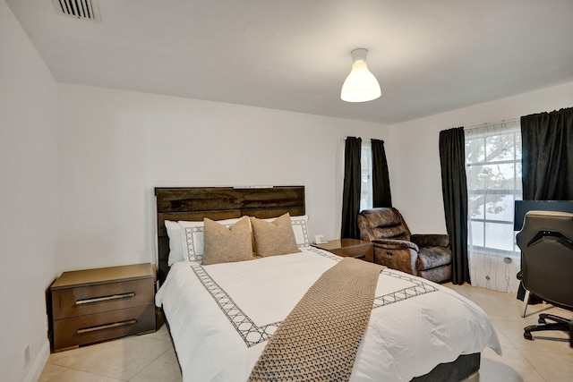 bedroom with light tile patterned floors and visible vents