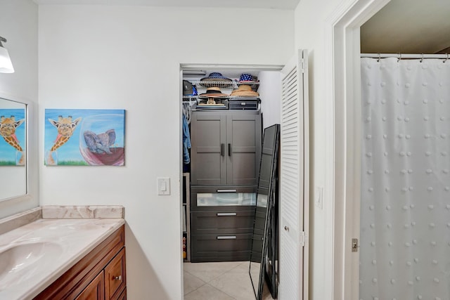 full bath featuring a shower with shower curtain, vanity, and tile patterned flooring