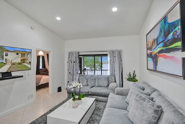 living room featuring light tile patterned floors, baseboards, lofted ceiling, and recessed lighting