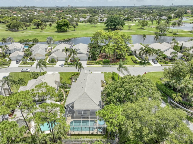 drone / aerial view with a residential view, a water view, and golf course view