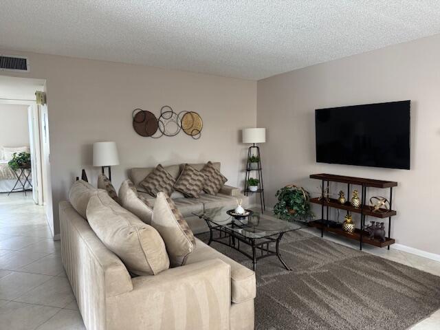 living room featuring visible vents and a textured ceiling