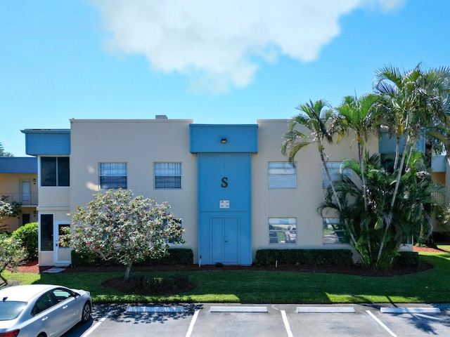 view of building exterior featuring uncovered parking