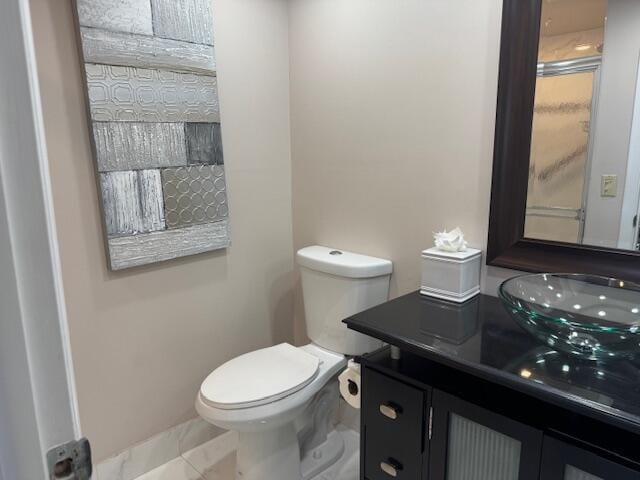 bathroom with tile patterned flooring, vanity, and toilet