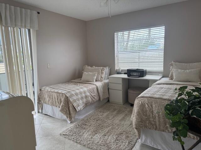 bedroom featuring light tile patterned floors and ceiling fan