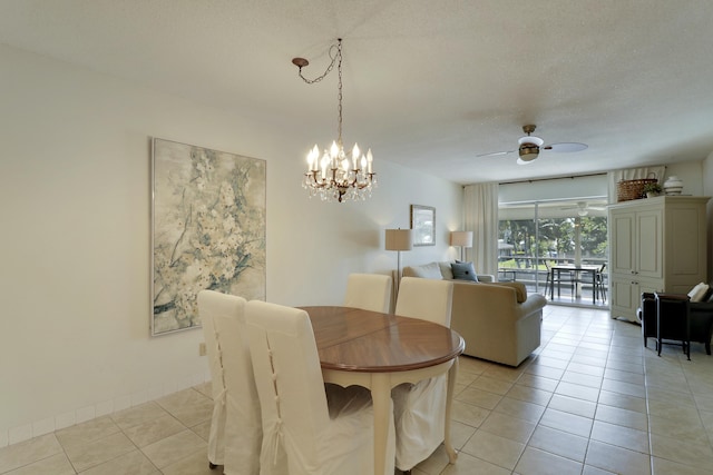 dining area featuring ceiling fan with notable chandelier, light tile patterned floors, a textured ceiling, and baseboards