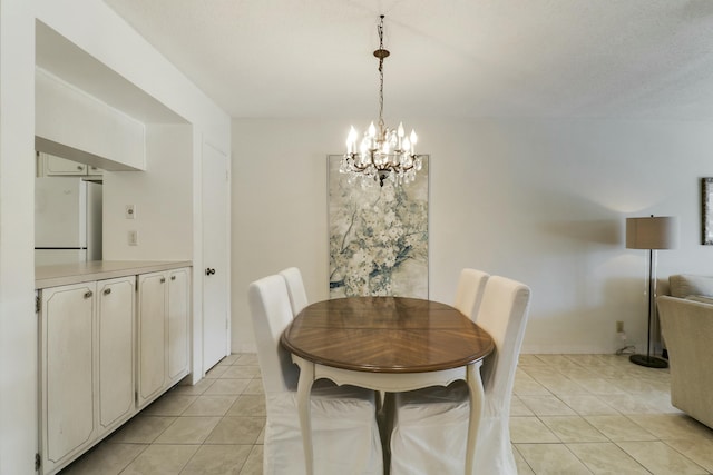 dining area featuring light tile patterned floors and an inviting chandelier