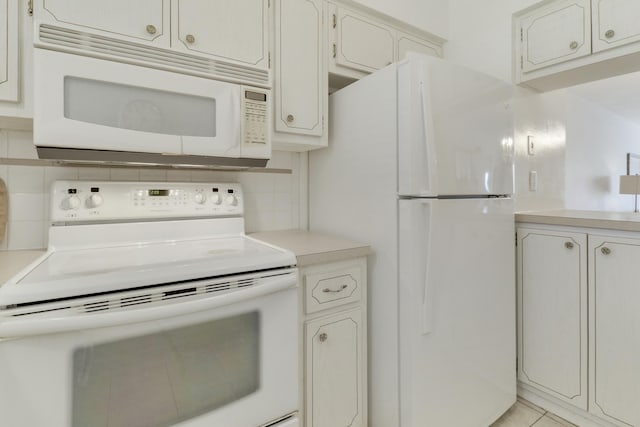 kitchen with light countertops, white appliances, and tasteful backsplash