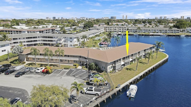 drone / aerial view featuring a water view and a view of city