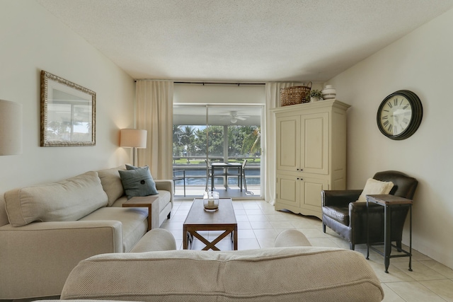 living area with light tile patterned flooring and a textured ceiling