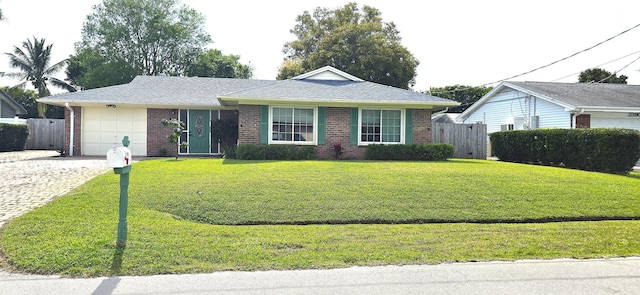 single story home featuring a garage, fence, and brick siding