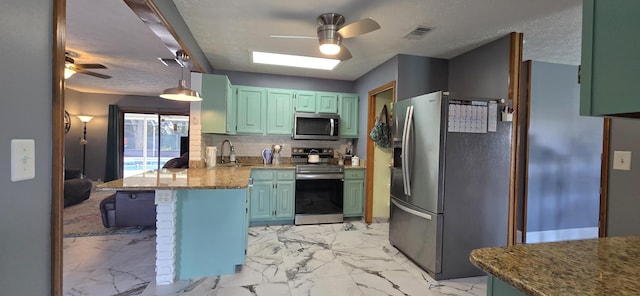 kitchen featuring visible vents, a peninsula, marble finish floor, stainless steel appliances, and green cabinets