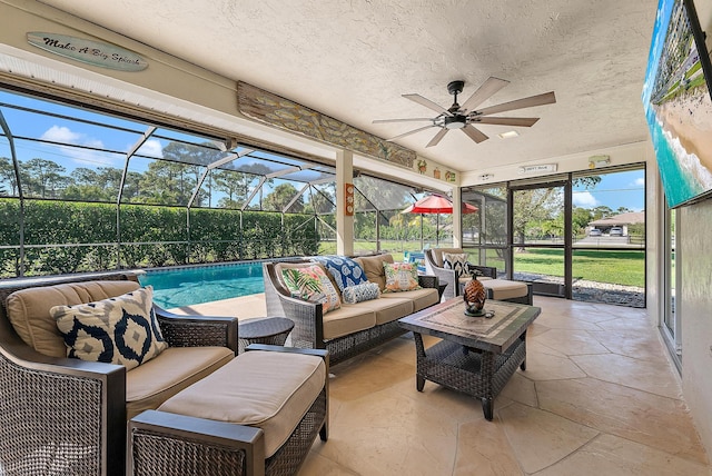 sunroom featuring a ceiling fan