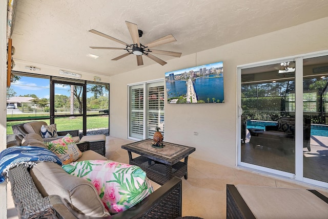 sunroom with a ceiling fan