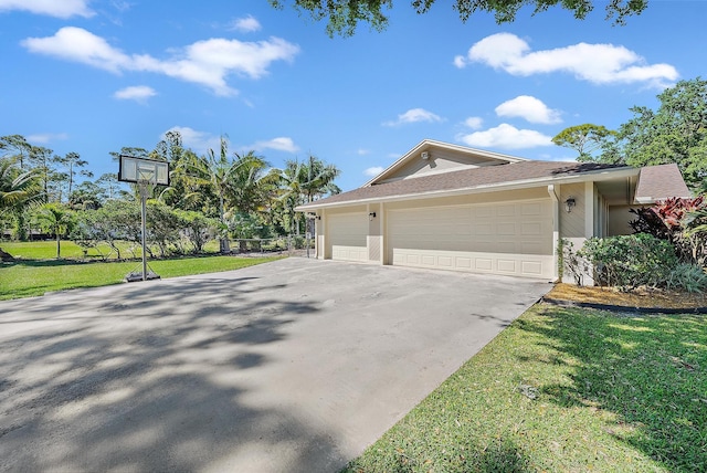 view of home's exterior featuring a lawn, a garage, driveway, and stucco siding