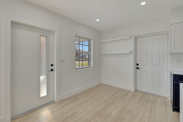 entrance foyer featuring light wood-style floors, baseboards, and recessed lighting