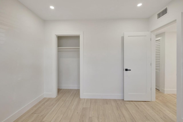 unfurnished bedroom with light wood-style floors, recessed lighting, visible vents, and baseboards