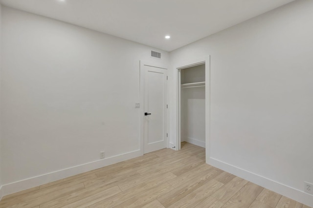 unfurnished bedroom with light wood finished floors, recessed lighting, a closet, visible vents, and baseboards