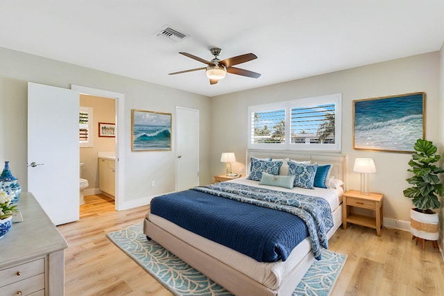 bedroom with light wood-style floors, baseboards, and visible vents