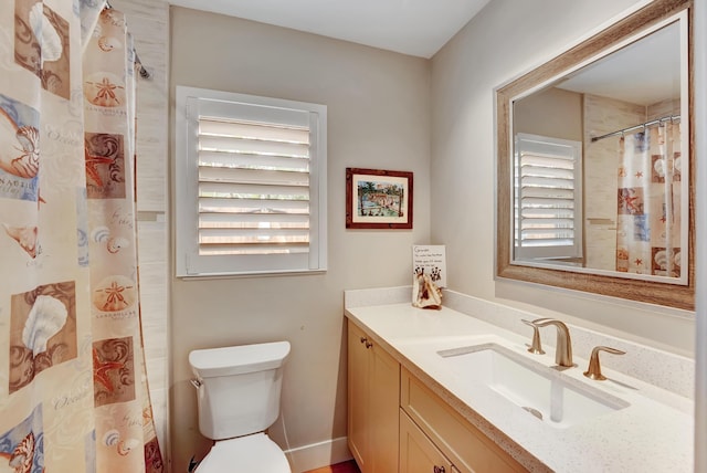 full bathroom with a shower with curtain, a healthy amount of sunlight, vanity, and toilet